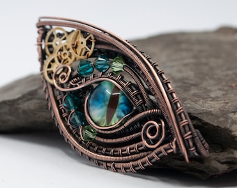 Colgante o broche de ojo de dragón Steampunk azul