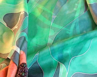 A large hand-painted silk scarf in shades of green with plant motifs, a gift for a woman, wife, friend, teacher, personalized gift