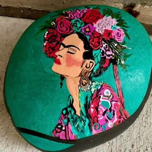 Frida painted bright and beautiful on a large stone!