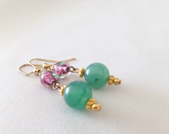 May include: A pair of earrings with green and pink glass beads and gold accents.