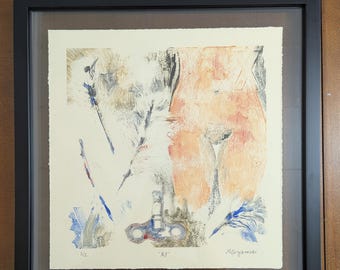 May include: A framed square print on off-white paper featuring an abstract composition with a peach-toned torso silhouette, a blue letter Y, a mechanical wind-up key, and feather-like strokes. The text XY is printed at the bottom centre.