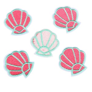 May include: Five embroidered iron-on patches in the shape of seashells. Four are pink with a white outline and one is green with a white outline.