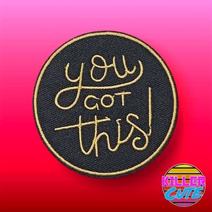 May include: A black circular patch with gold embroidery that reads "you got this!"