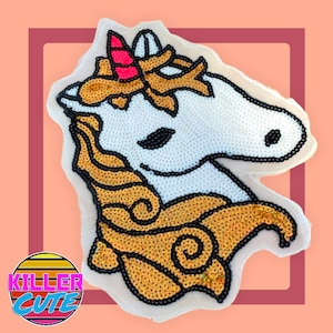 May include: A white unicorn with a gold sequined mane and horn. The unicorn is outlined in black and has a pink horn.