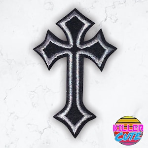 May include: Black and silver embroidered cross patch with a detailed design.