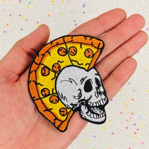May include: An embroidered iron-on patch featuring a white skull with a slice of pizza for a mohawk. The pizza is yellow with orange crust and red pepperoni.
