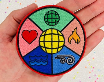 May include: A round embroidered patch with a red border. The patch is divided into five sections, each with a different color and symbol. The top section is green with a green globe, the next section is pink with a red heart, the next section is yellow with a yellow globe, the next section is orange with a flame, and the bottom section is blue with a blue wave.