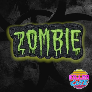 May include: Green embroidered "ZOMBIE" patch with dripping green accents on a black background. The patch is surrounded by a black and green background with a "Killer Cute" logo in the bottom right corner.