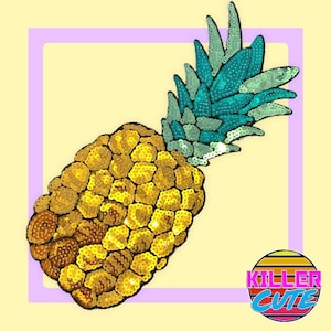 May include: A gold and turquoise sequined pineapple patch. The pineapple is made of gold sequins and the leaves are made of turquoise sequins.