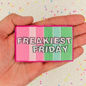 May include: A pink and green embroidered patch with the text "Freakiest Friday" in white.