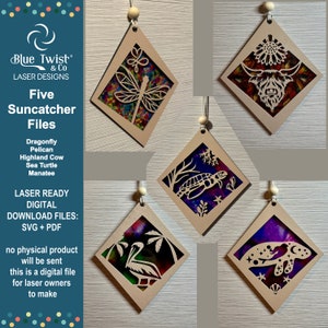 May include: Five laser-cut wooden suncatcher designs featuring various animal and nature themes. The designs include a dragonfly, pelican, Highland cow, sea turtle, and manatee. Each design is cut out of a diamond-shaped piece of wood and features intricate details.