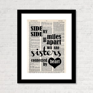 May include: Black and white typography print on a vintage book page background. The text reads "Side by side or miles apart we are sisters connected by heart". A black heart is included in the text.