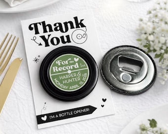 May include: A black bottle opener with a green and white record label design, personalized with names and a date, next to a card that says "Thank You". The card also says "I'M A BOTTLE OPENER!"