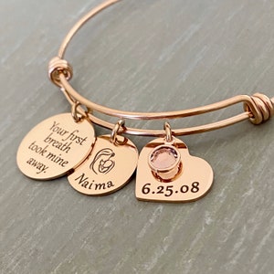 rose gold charm bracelet with 3 charms and a june birthstone