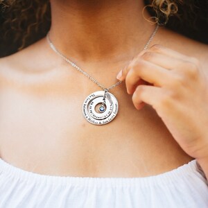 woman wearing the double pendant grief necklace in silver.