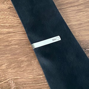 sheriff tie clip on a black silk tie to show size