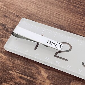 tie clip on ruler showing length of 2 inches