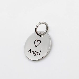 May include: Silver charm with a heart and the word "Angel" engraved on it.
