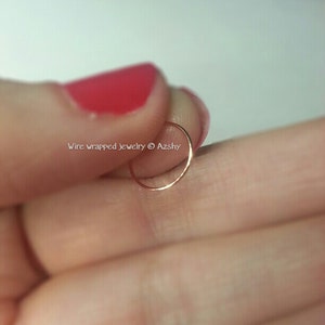 May include: A thin gold hoop nose ring.  Wire wrapped jewelry &copy; Azshy