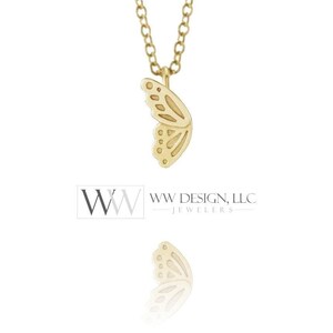 May include: A gold-toned necklace featuring a pendant shaped like a single butterfly wing. The wing has cut-out details and a delicate chain. The image includes the text WW DESIGN, LLC JEWELERS. The pendant is suspended from a simple link chain.