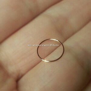 May include: A thin gold nose ring hoop. The ring is made of wire and is very delicate.