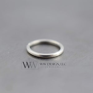 May include: A silver ring with a smooth, polished finish. The ring is a simple, classic design.