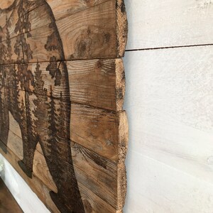 This shows the rustic rough wood edge or the bear wall art.