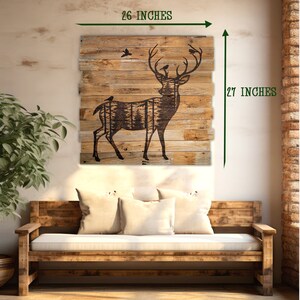 A square wood wall hanging featureing a deer and forest silhoette. This piece hangs in an entryway hall and measures 26 x 27 inches.