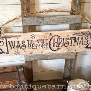 A horizontal wood sign. Twas the night before Christmas and reindeer are wood burned decoratively. The sign hangs with a piece of rope.