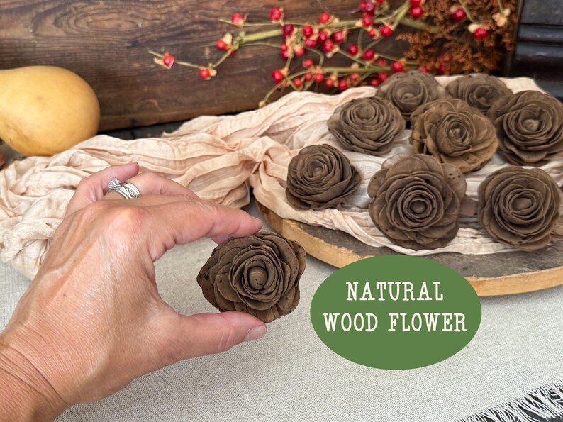 This shows me holding the wood flower blossom in a chocolate brown color. A wood bird house sits in the background