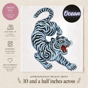 May include: An iron-on patch featuring a detailed illustration of a tiger in light blue and black. The tiger is approximately 10.5 inches across. The patch includes the text "Ocean" and instructions for application.