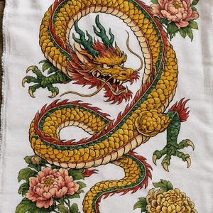 May include: A white fabric cloth featuring a detailed illustration of a long, winding yellow dragon with green scales, red accents, and sharp claws. The dragon is surrounded by pink and yellow peony flowers with green leaves on a plain background.