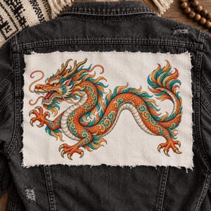 May include: A black denim jacket featuring a large, rectangular fabric patch on the back. The patch displays a detailed illustration of a long, serpentine dragon with orange, teal, and yellow scales, flowing mane, and sharp claws on a cream background.