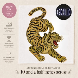May include: A gold and black embroidered tiger patch, approximately 10.5 inches across, with the text "GOLD". The patch is iron-on and washable, suitable for clothing, bags, and jackets. The tiger is depicted in a dynamic pose with its mouth open.