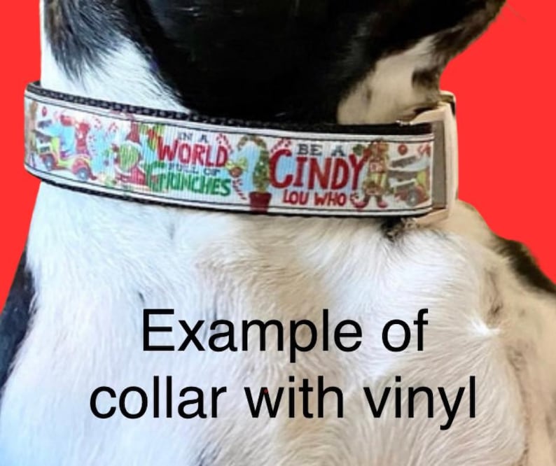 May include: A festive dog collar with a colorful design featuring characters and phrases from a holiday story. The collar has the text "IN A WORLD FULL OF GRINCHES" and "BE A CINDY LOU WHO". The image also includes the text "Example of collar with vinyl".
