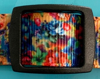 May include: A colorful floral patterned dog collar with a black plastic buckle.