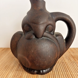 Dark Stained Pottery Jug. Eagle holding Snake Figural Jug