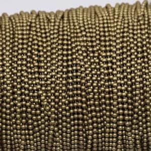 May include: A spool of gold-colored metal chain with small round links. The chain is tightly wound and appears to be made of a durable material.