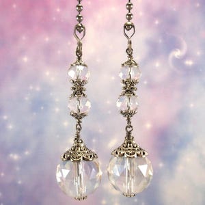 May include: Two silver chain light pull pendants with clear crystal beads and large faceted crystal drops.