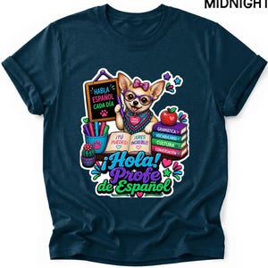 May include: A midnight blue t-shirt featuring a graphic of a chihuahua wearing glasses and a bow, holding a pen over an open book. The design includes a chalkboard with the text Habla Español Cada Día, a stack of books, and the text ¡Hola! Profe de Español.