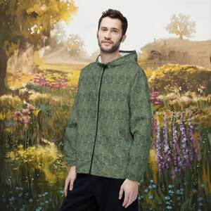 May include: A green hooded jacket with a zipper closure and a leafy pattern. The jacket is made of a lightweight fabric and has a relaxed fit.