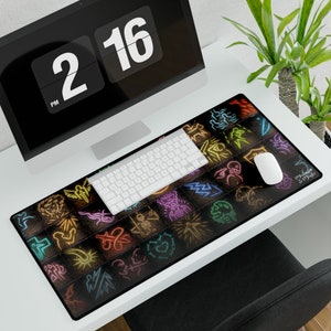 May include: A black gaming mouse mat with a colourful neon design of various symbols. The mouse mat features the text "Mystic & Magic".