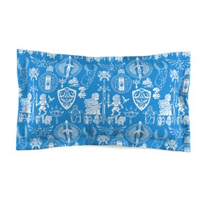 May include: A blue pillowcase with a white pattern of video game characters and symbols. The pattern includes swords, shields, and other imagery.