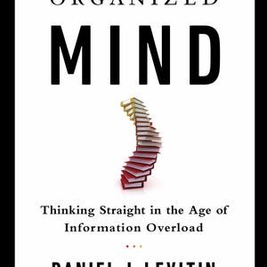 May include: A book cover titled The Organized Mind by Daniel J. Levitin. The white cover features black text and a central graphic of a spiraling stack of books with red covers and yellow spines. The subtitle reads Thinking Straight in the Age of Information Overload.
