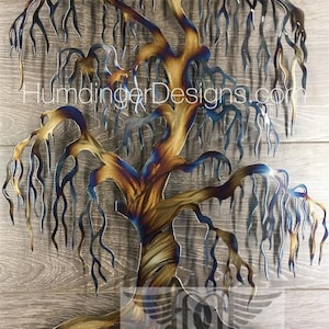 May include: A metal sculpture of a weeping willow tree with a blue and gold finish. The tree is made of metal and has a realistic design. The sculpture is a great way to add a touch of nature to your home decor.