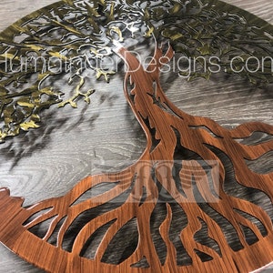 May include: A metal tree of life wall art with a gold and brown finish. The tree has intricate branches and roots. The background is a wood grain pattern.