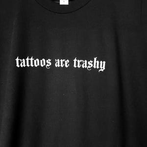 May include: A set of three ceramic mugs with a speckled, matte finish. The mugs are in shades of cream, light gray, and dark gray. Each mug has a simple, minimalist design and a rounded handle.