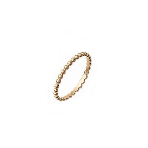 May include: A gold beaded ring. The ring is thin and delicate, with small, evenly spaced beads.