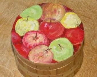 May include: A round wooden box with a painted design of red, green, and yellow apples. The box has a lid and is made of wood.