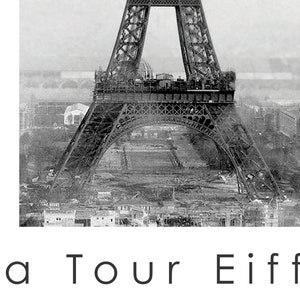 May include: Black and white vintage photograph of the Eiffel Tower under construction. The image shows the intricate iron lattice structure against a cityscape background. The text "La Tour Eiffel" is at the bottom.